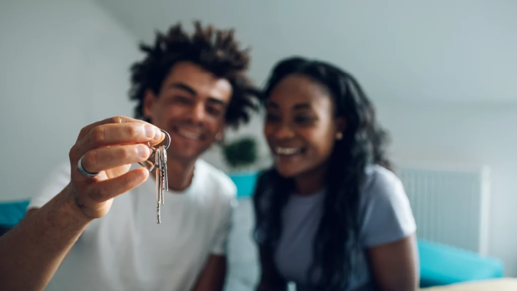 Couple with keys to new apartment.
