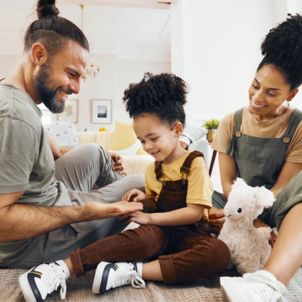 Family on the floor of living room playing together.